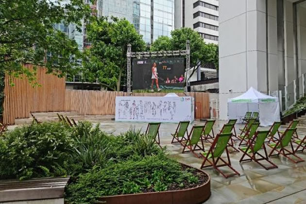 The open-air screen showing Wimbledon 2021 in the public plaza