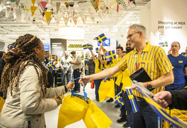 Staff greet customers at the store opening