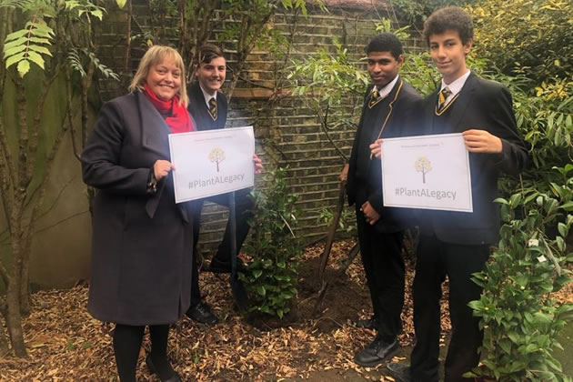 Headteacher Sally Brooks with three of her Fulham Cross Academy Trust students planting a tree as part of #PlantALegacy